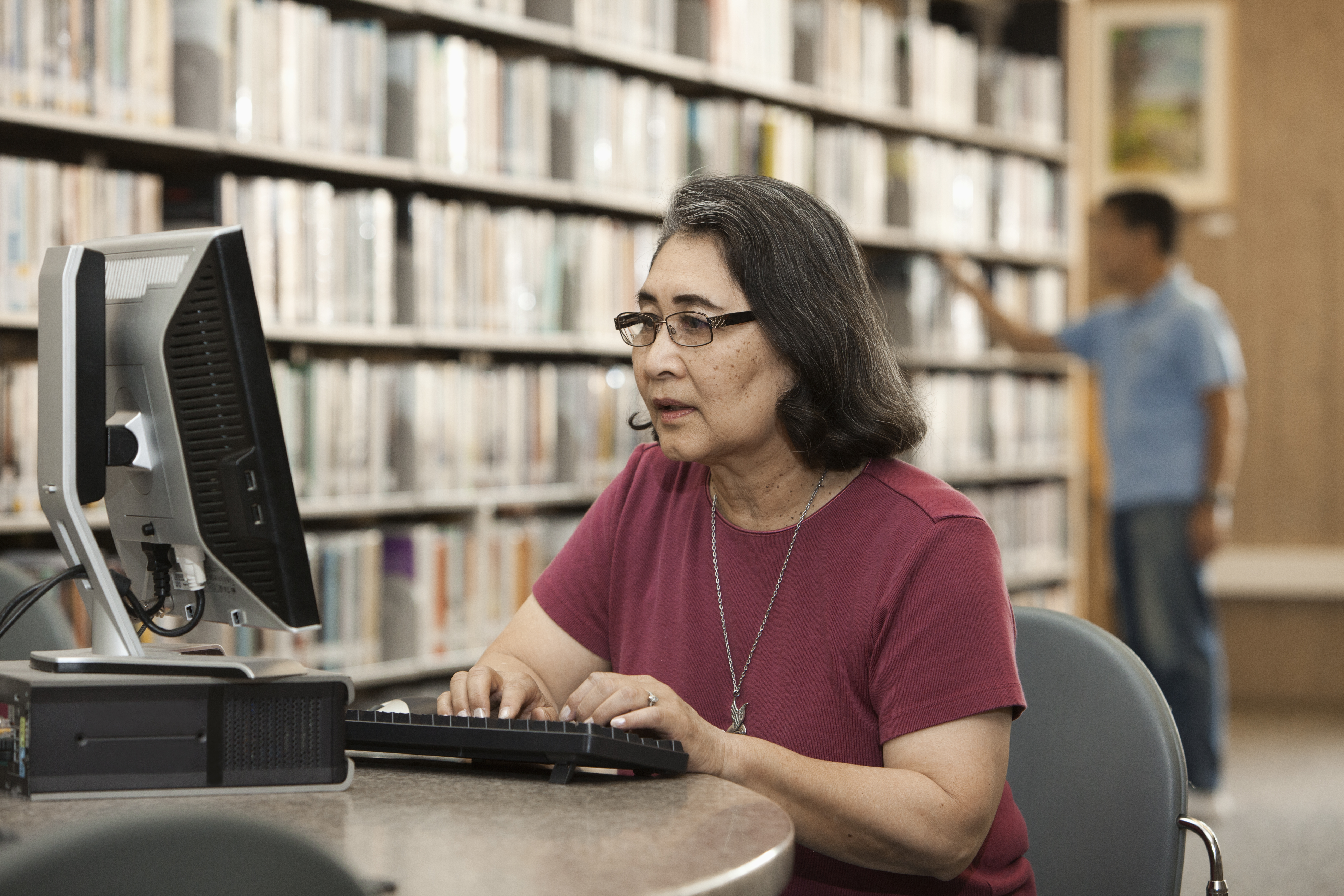 Woman using a public computer at the library