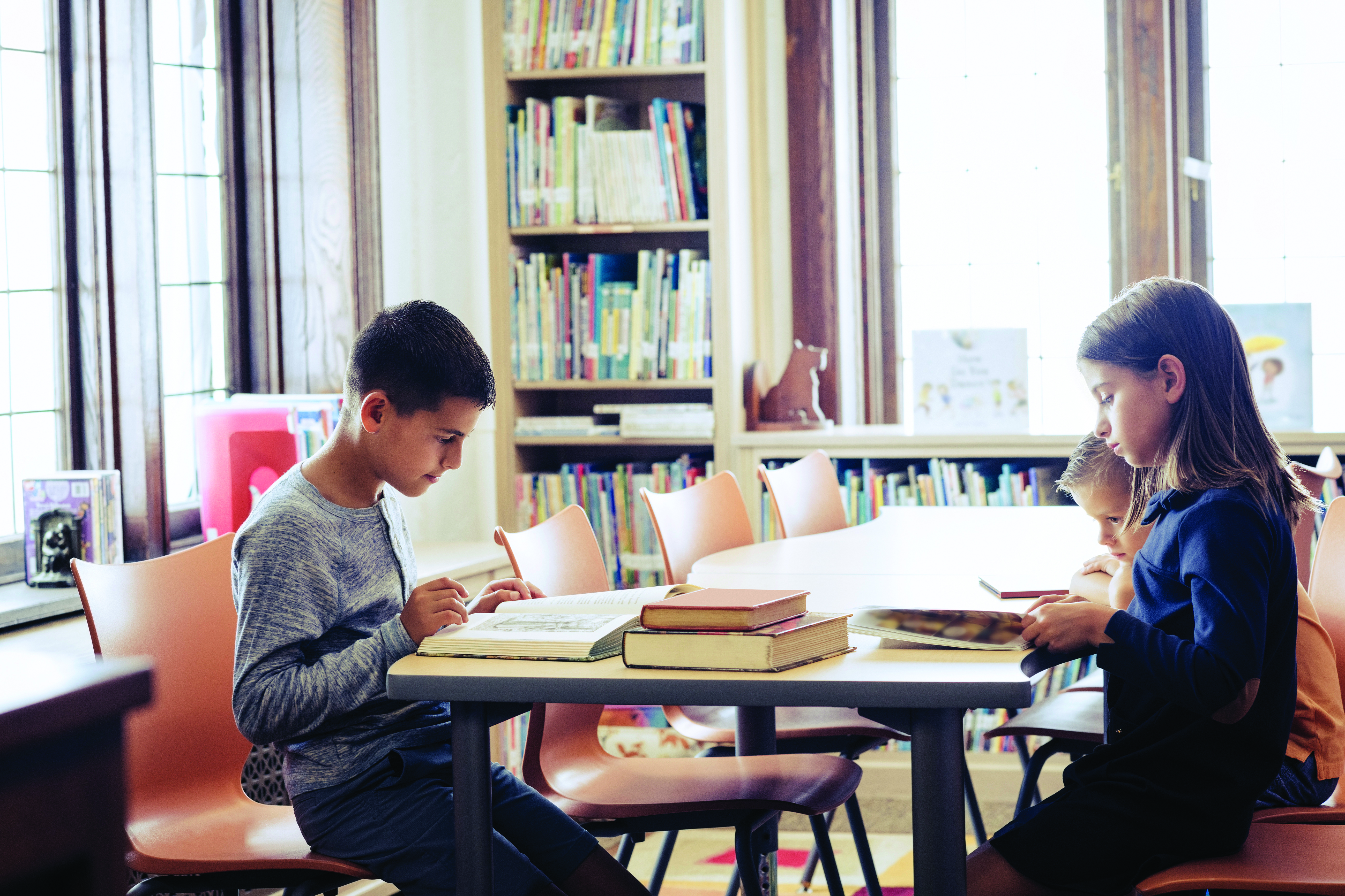 Children studying at a library table